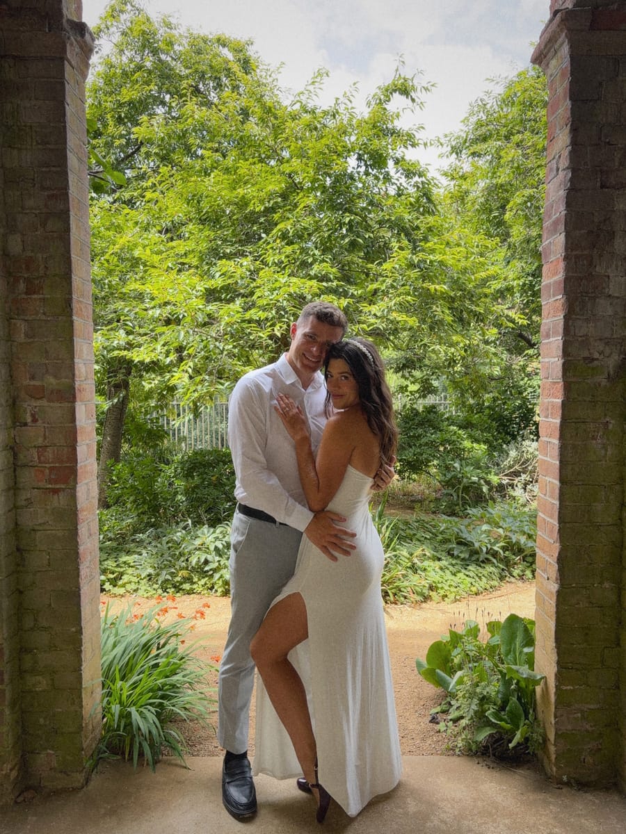 Justyna and Lewis embracing in a garden